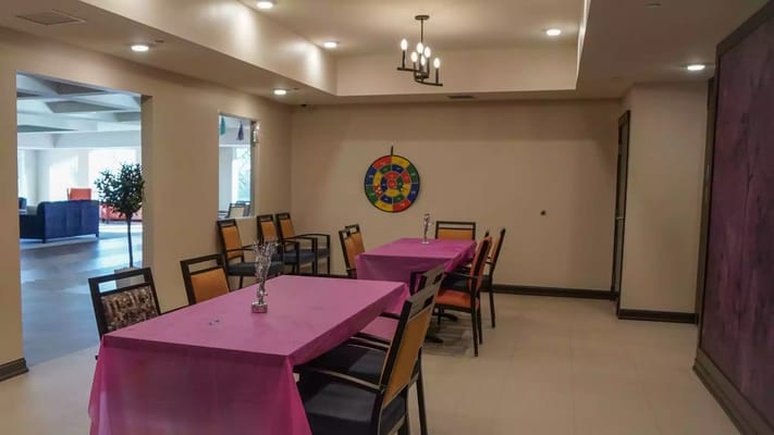 A common area with tables and vibrant decorations