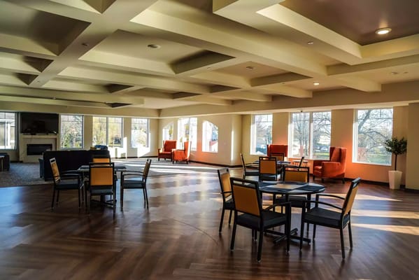 Bright common area with seating and large windows