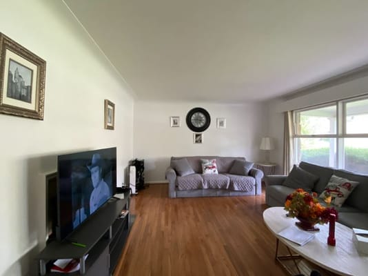 Bright living room with comfortable seating and a television