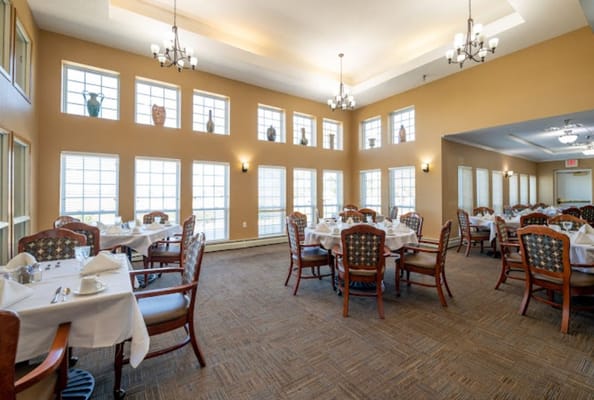 Bright dining area with tables set for residents
