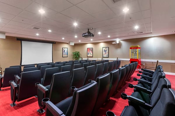 Interior view of the theater room with rows of seats and a projection screen