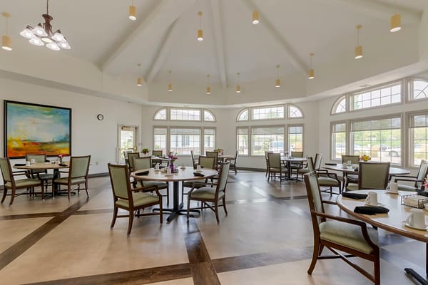 Interior view of the dining room with tables and chairs in Silvercrest Garner Senior Living