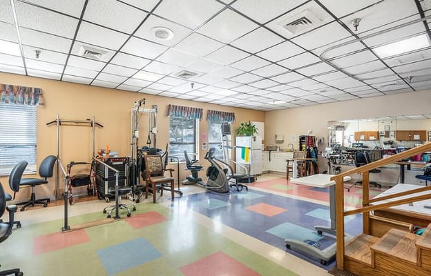 Rehabilitation room with exercise equipment and therapy area
