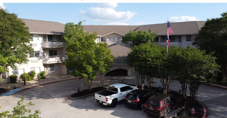 Exterior view of the Solstice Senior Living facility with flag.