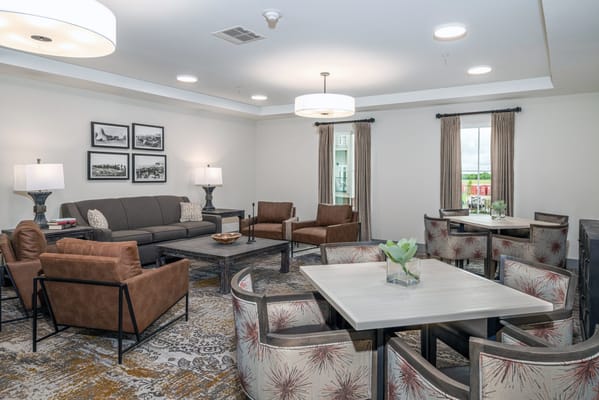 Cozy lounge area with seating and tables in Sooner Station