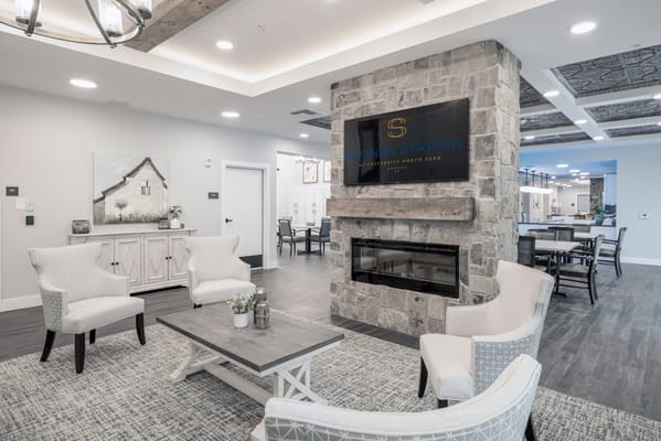 Cozy common area with seating and stone fireplace.