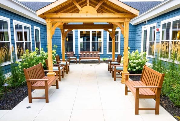 Outdoor seating area with benches and greenery