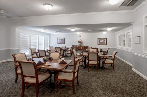 Dining area with tables and chairs in a well-lit setting