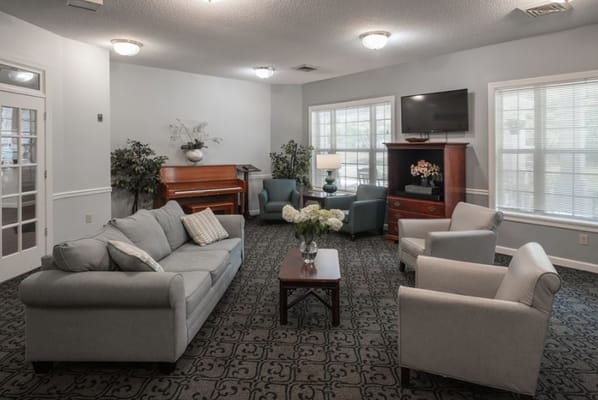 Cozy common area with seating and a piano