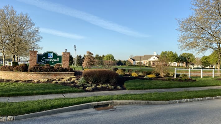 Entrance sign of Springmill Community with landscaped grounds