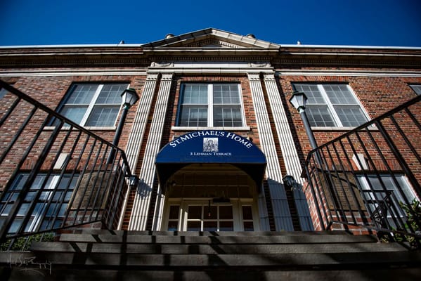 Front entrance of St. Michael's Home with steps and sign