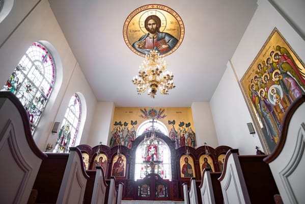 Interior view of the chapel with stained glass windows and icons