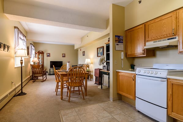Cozy resident room with kitchen area and dining table