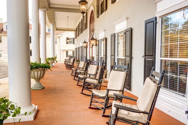 A serene porch with rocking chairs and hanging lanterns at St. Augustine Plantation.