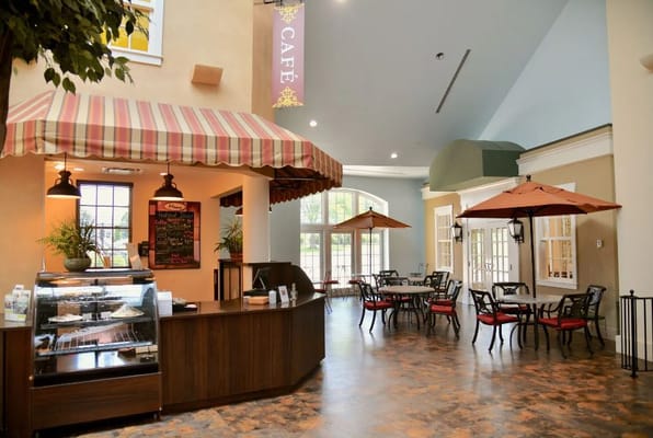 Interior view of the café with tables and a service counter.