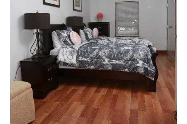A cozy twin bedroom with dark wood furniture