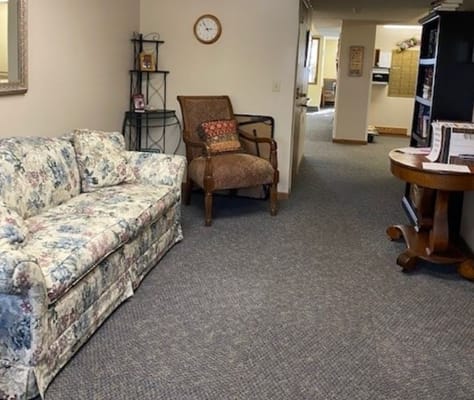 Cozy living room with floral couch and armchair