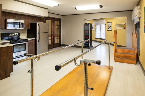 Therapy room featuring equipment for physical rehabilitation.