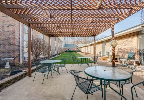 Outdoor patio area with seating and greenery