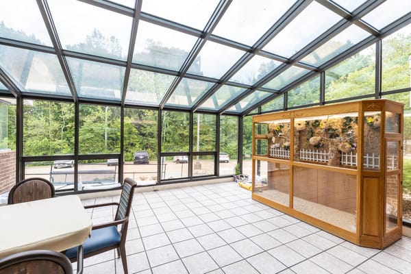 Bright sunroom with seating and garden view