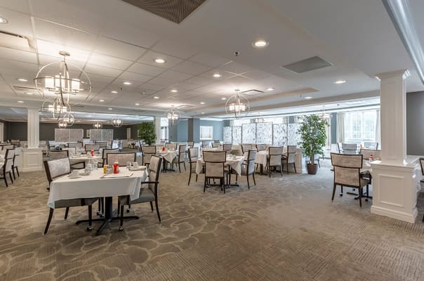 Spacious dining area with tables set for meals at StoryPoint Naperville