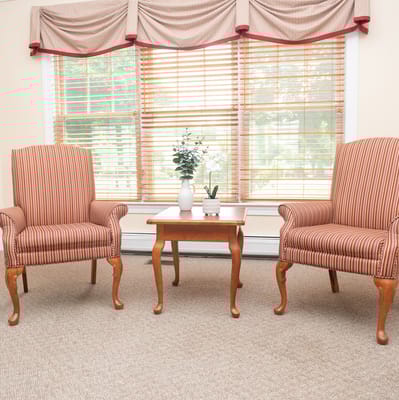 Cozy sitting area with striped chairs and a table