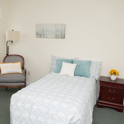 Cozy resident room with bed and chair