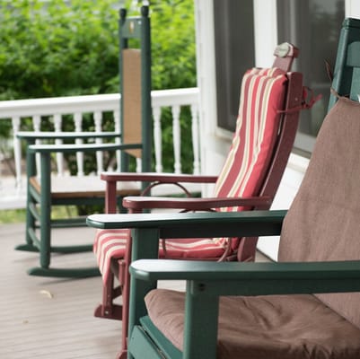 Rocking chairs on a porch at a senior living facility