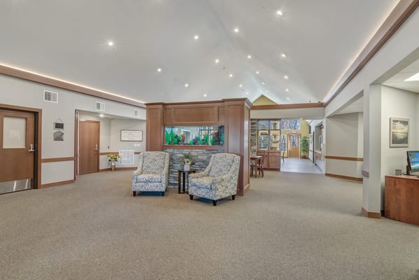 Bright common area with seating and an aquarium