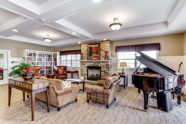 Comfortable living room with a piano and bookshelf