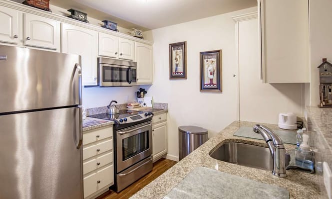 Modern kitchen featuring stainless steel appliances and granite countertops