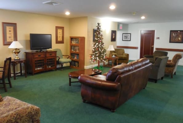 Common area in a senior living facility with a holiday tree