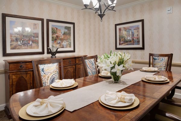 Dining table set with plates and flowers in a decorated room