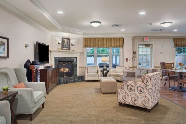 Cozy common area featuring comfortable seating and a fireplace