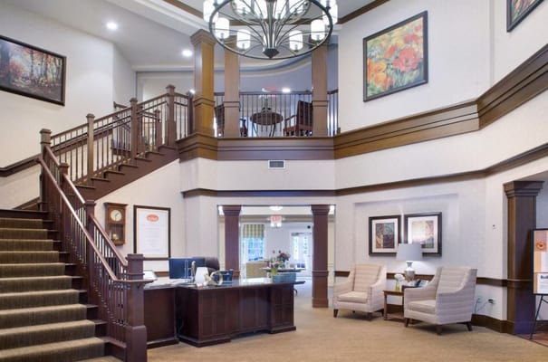 Bright and welcoming lobby with a staircase and seating area