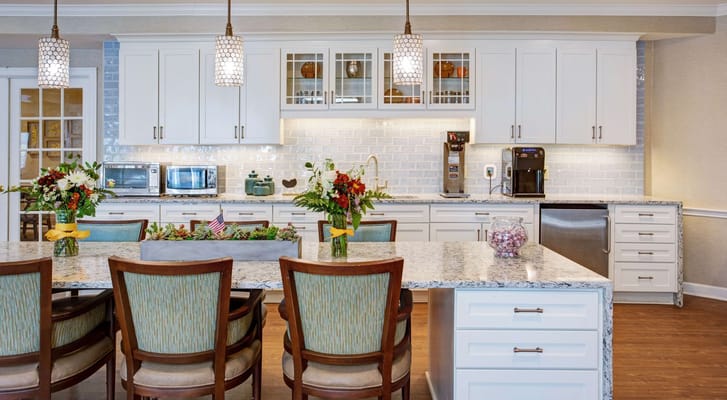 Spacious kitchen with modern appliances and decorative flowers