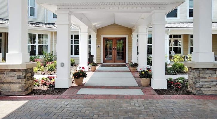 Welcoming entrance with flower pots at Sunrise of Franklin Lakes