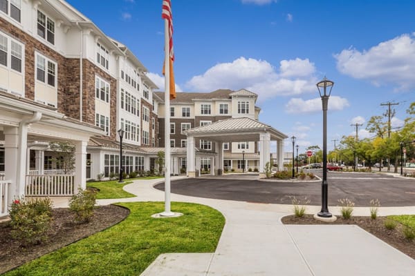 The entrance of Sunrise of New Dorp, showcasing the building structure and landscaping.