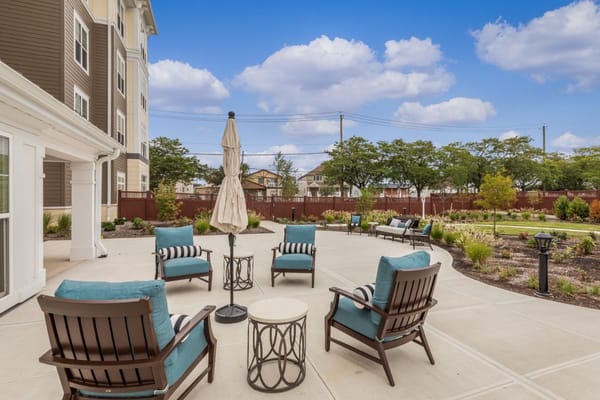 Comfortable seating area on the outdoor patio of Sunrise of New Dorp