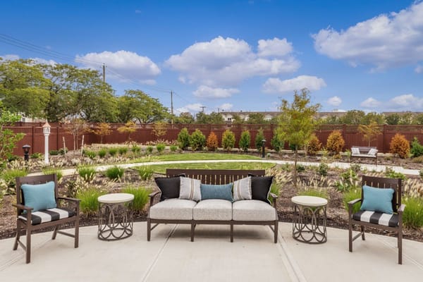 Patio seating area with plants in the background