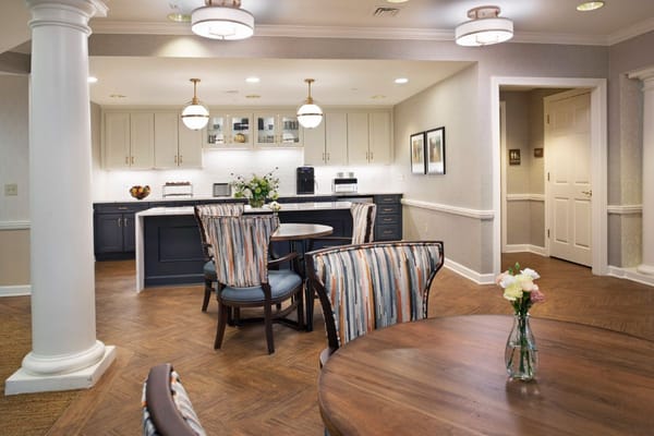 Spacious common area with dining tables and kitchen facilities.