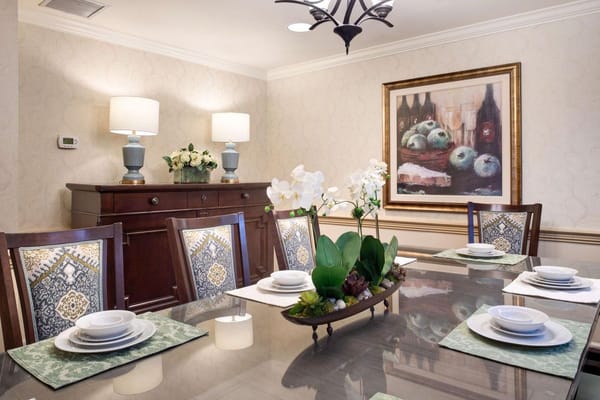 Dining area with table settings and floral decoration