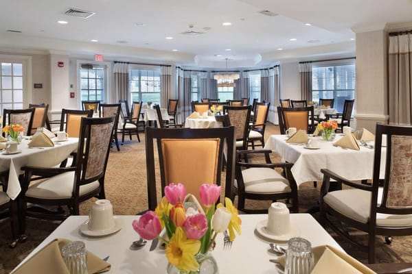 Elegant dining room setup with tables and flowers