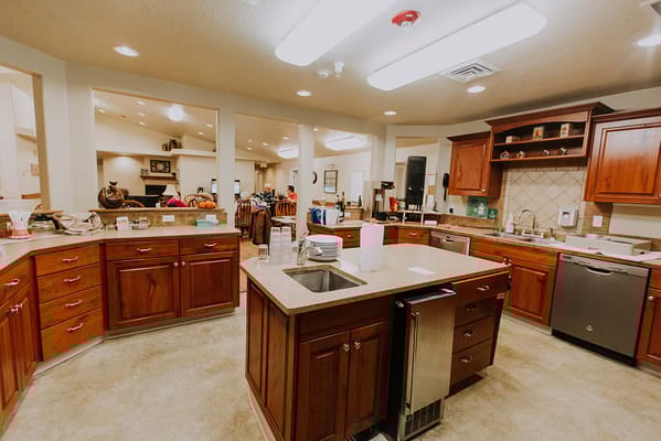 Interior kitchen area with residents and staff