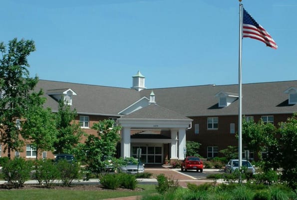 Front view of Tabor Hills with flag and landscaped entrance