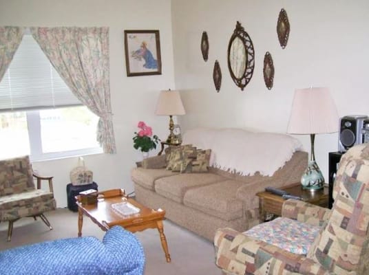 Living room with comfortable seating and decorative mirrors