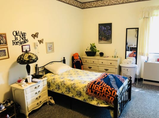 A cozy resident room with floral bedding and decor