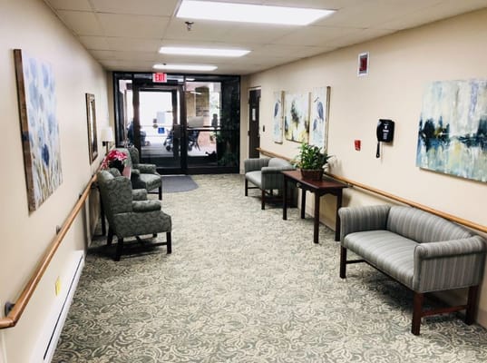 Bright interior hallway with artwork and seating