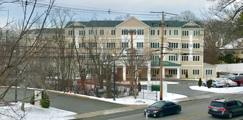 Exterior view of The Arbors at Stoneham senior living facility.