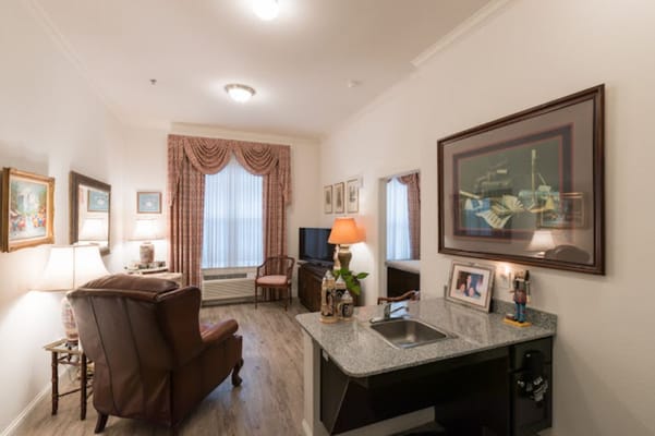 Cozy living room featuring a comfortable chair and kitchenette
